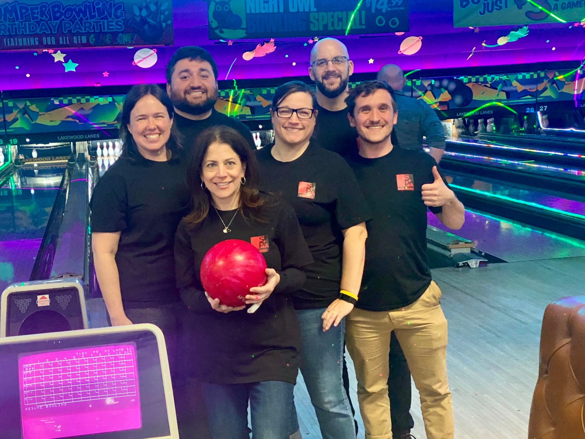 Group of friends enjoying cosmic bowling night