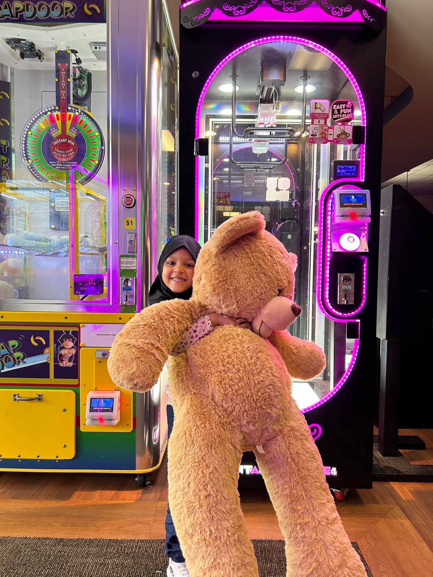 Child with prize from arcade at Lakewood Lanes