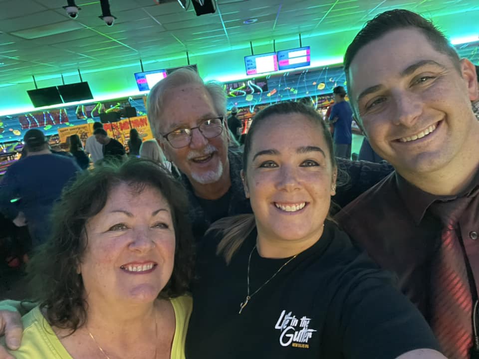 Family enjoying cosmic bowling at Lakewood Lanes